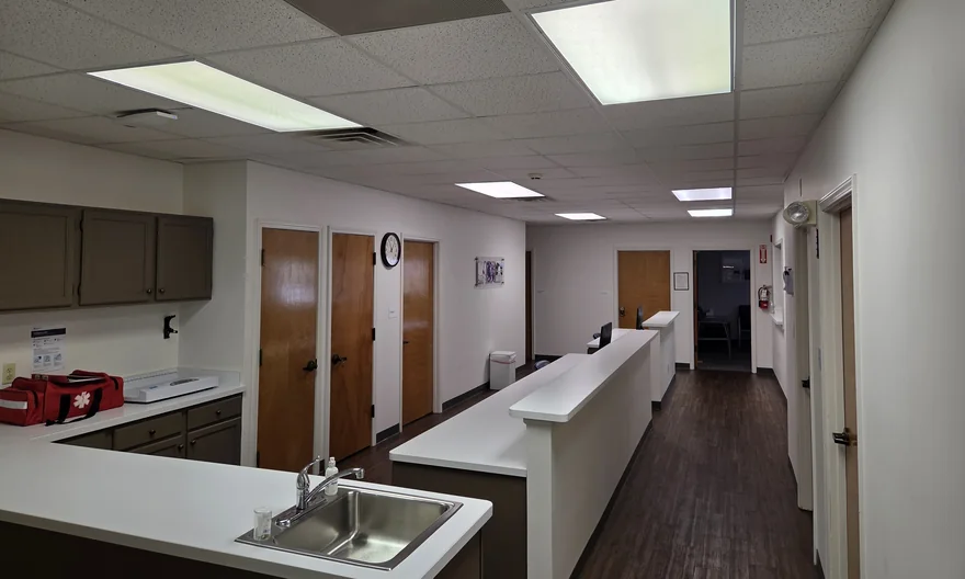 Clean reception and common area with clear counters, sink and floor after service.